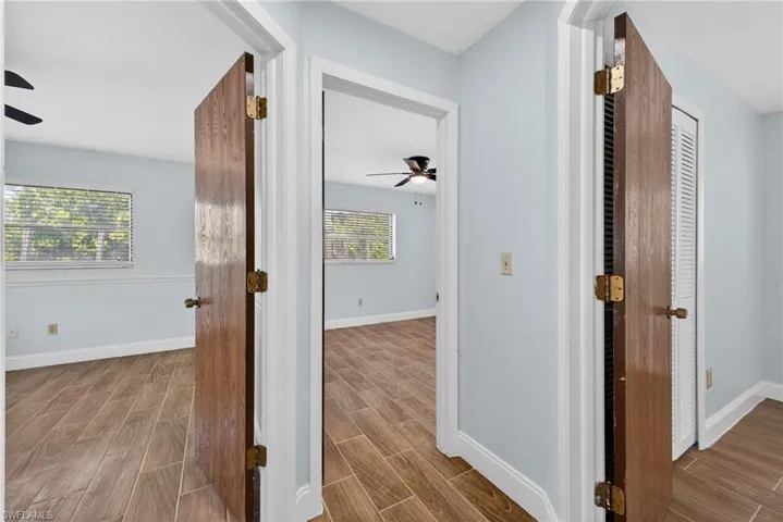 Corridor featuring wood finish floors