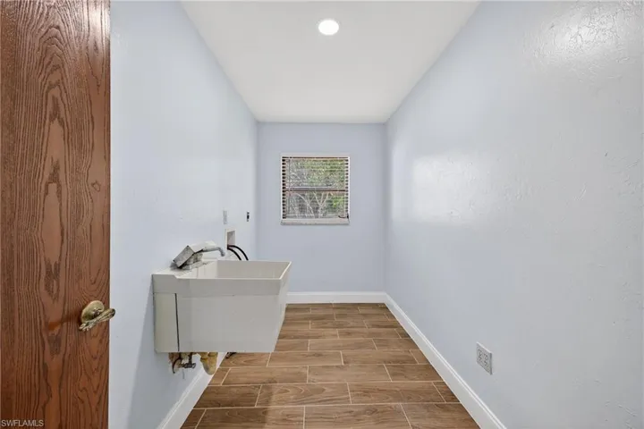 Laundry area featuring wood tiled floors and hookup for a washing machine
