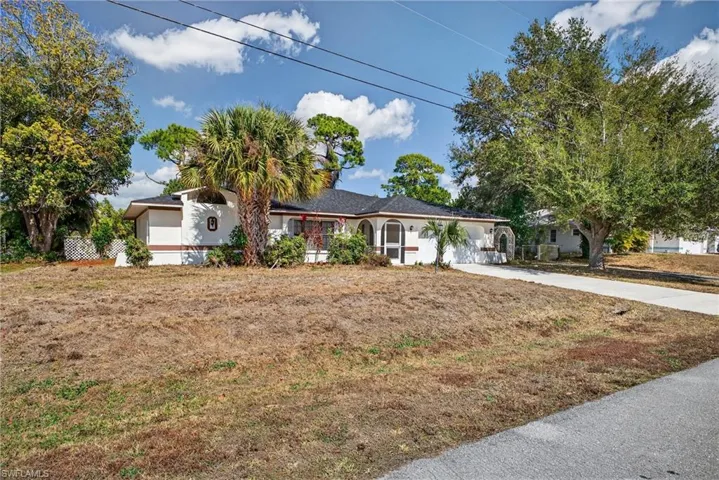 Single story home with stucco siding and a front lawn