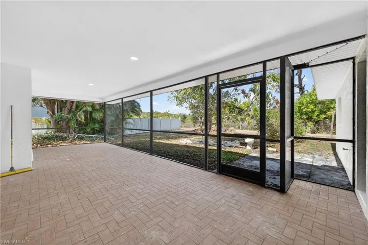 Unfurnished sunroom featuring plenty of natural light