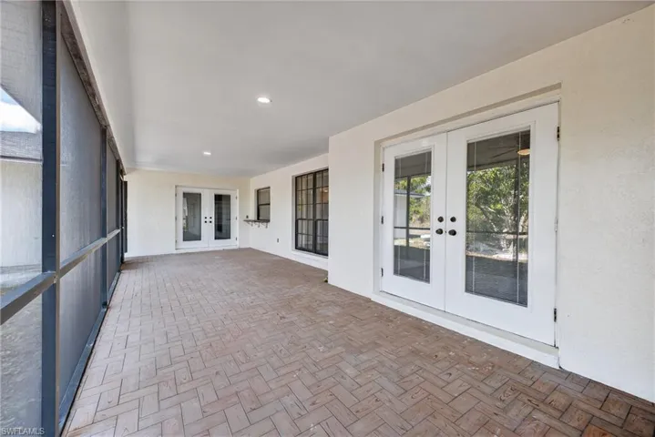 Unfurnished sunroom with french doors