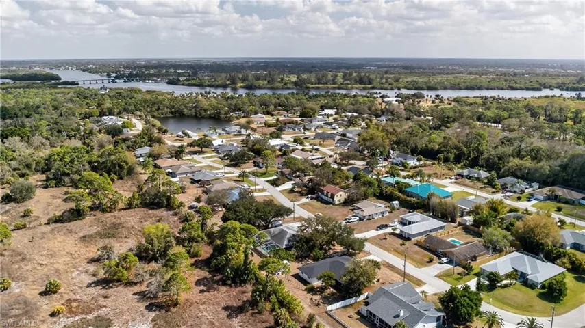 Aerial view of residential area featuring a large body of water