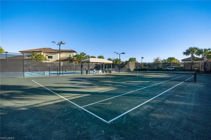 View of tennis court with community basketball court