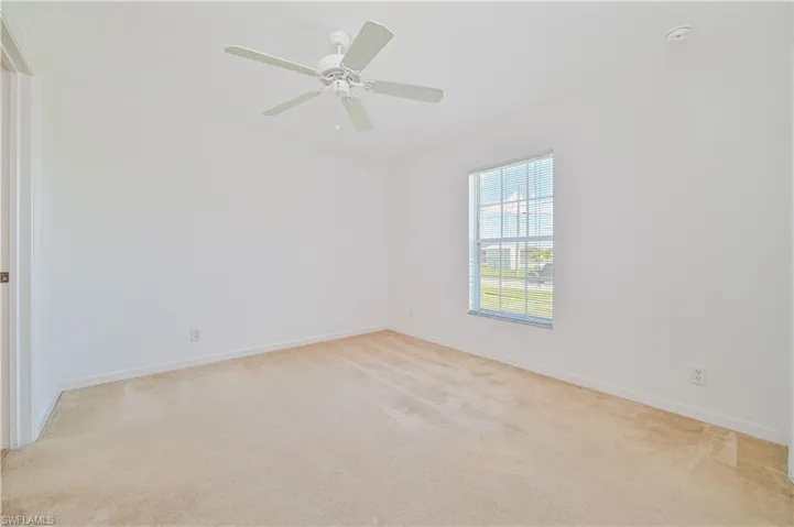 Spare room featuring ceiling fan and carpet flooring