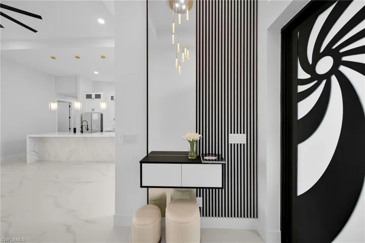 Detailed view of recessed lighting and stainless steel refrigerator