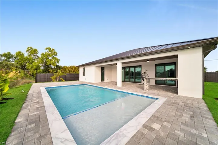 View of swimming pool with a fenced backyard and a patio area