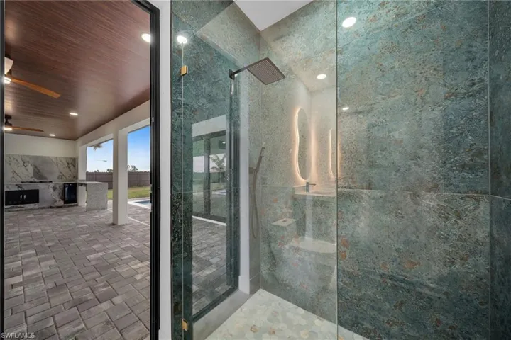 Full bath with walk in shower, recessed lighting, wood ceiling, and tile walls