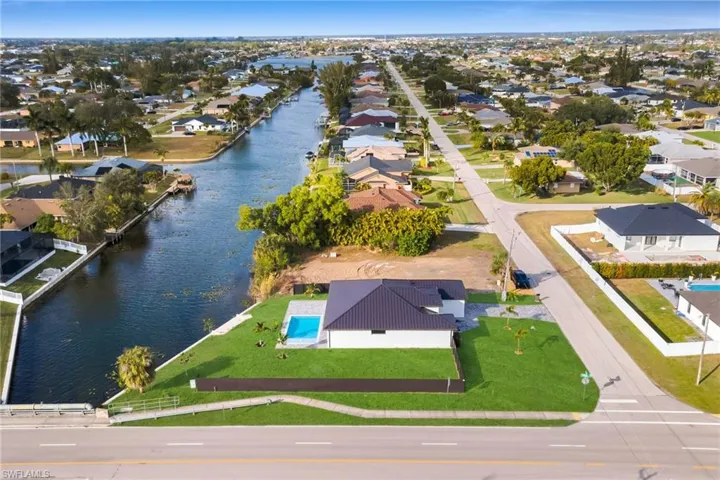 Aerial view of residential area featuring a nearby body of water