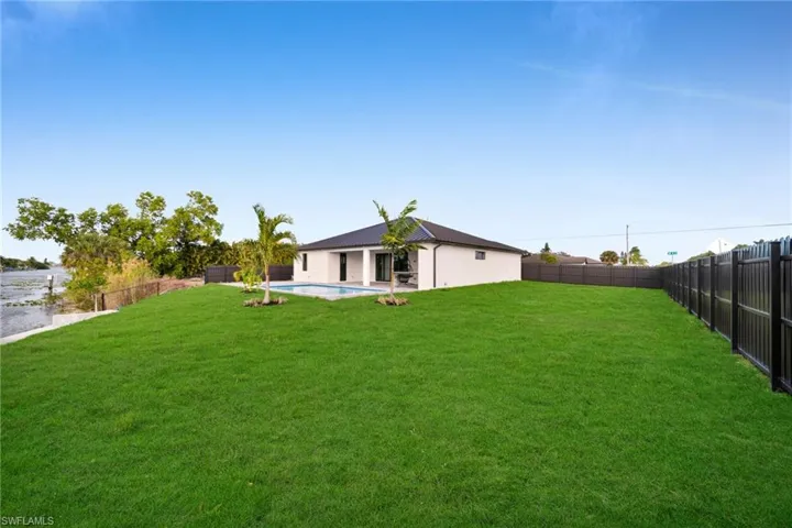 Rear view of property with a patio and a fenced backyard
