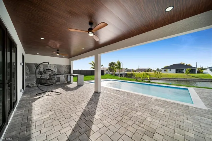 View of patio / terrace featuring a ceiling fan and a residential view
