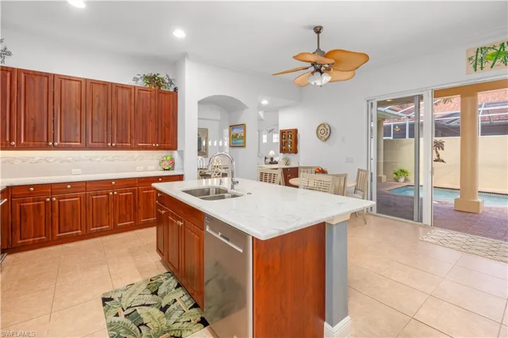 Kitchen with dishwasher, a sink, light tile patterned floors, a ceiling fan, and recessed lighting