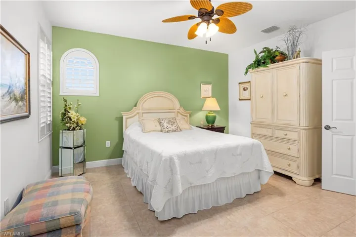 Bedroom featuring light tile patterned floors and a ceiling fan