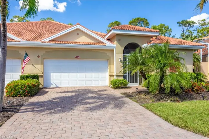 Mediterranean / spanish house featuring stucco siding, a garage, decorative driveway, and a tiled roof