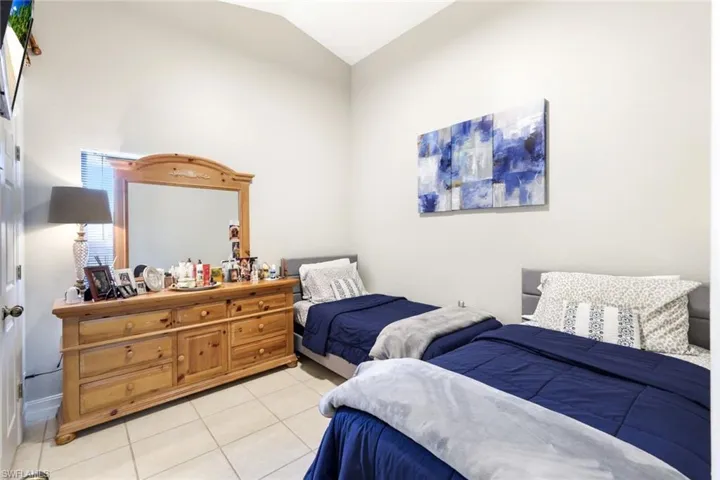Bedroom featuring lofted ceiling and light tile patterned flooring