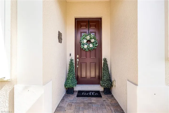 Entrance to property with stucco siding
