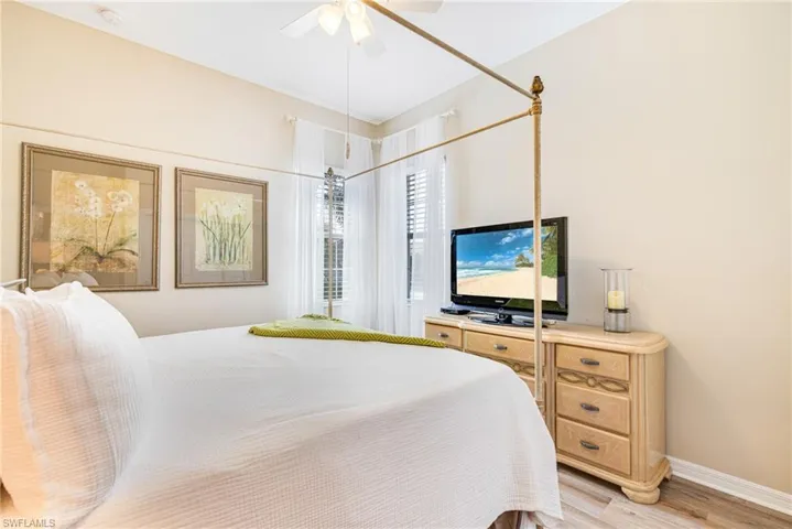 Bedroom featuring wood finished floors and ceiling fan