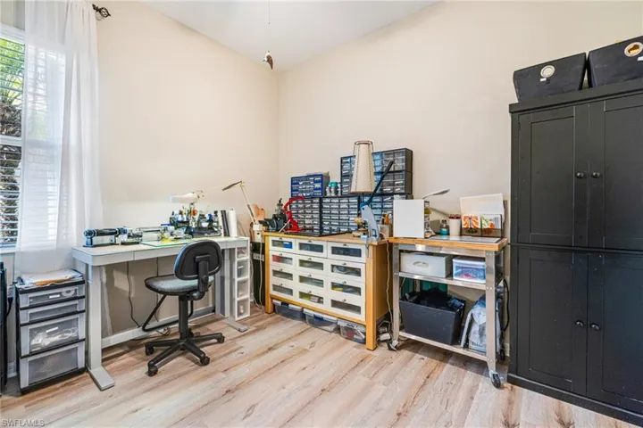 Bedroom, craft room or office featuring light wood-style flooring