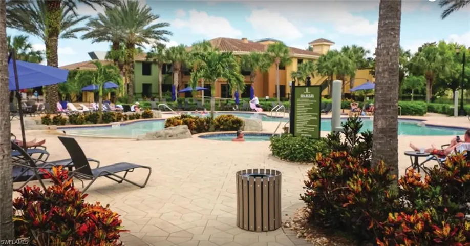 Community pool featuring a hot tub and a patio