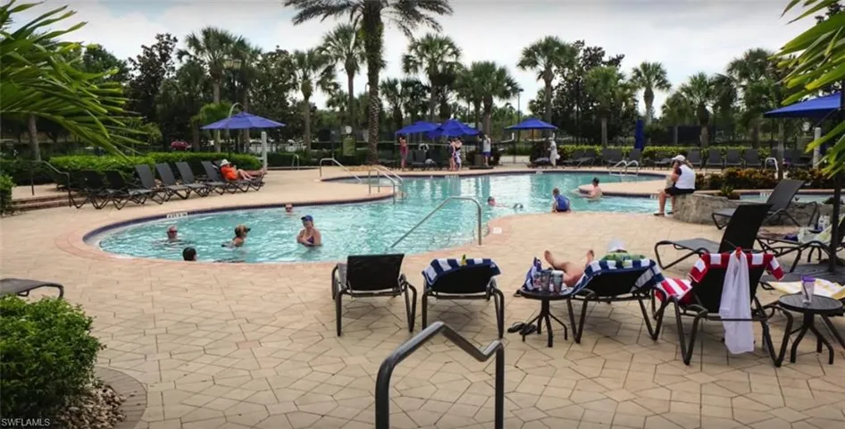 Community pool with a patio