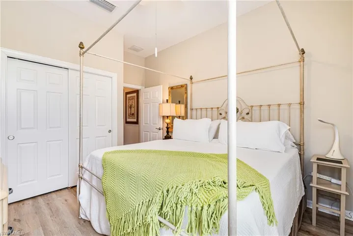Bedroom featuring wood finished floors and a closet
