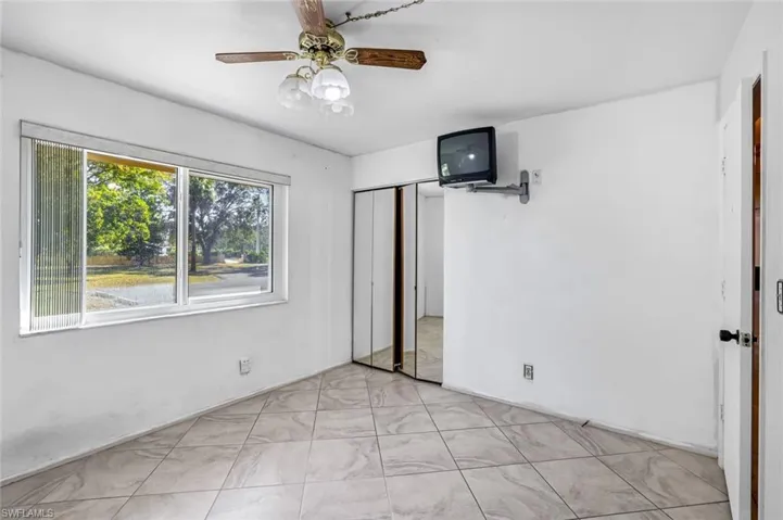 Unfurnished bedroom featuring a ceiling fan and a closet