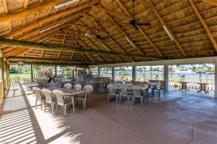 View of patio with a water view and ceiling fan