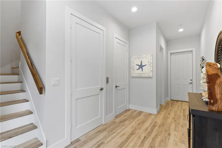 The foyer includes garage access, a private elevator, and access to the lanai and pool deck