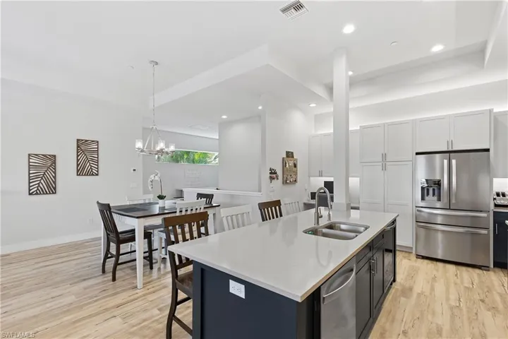 Open concept with high ceilings and plenty of cabinets in the kitchen including home office space