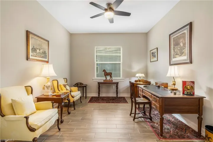 Office space featuring wood tiled floors and a ceiling fan