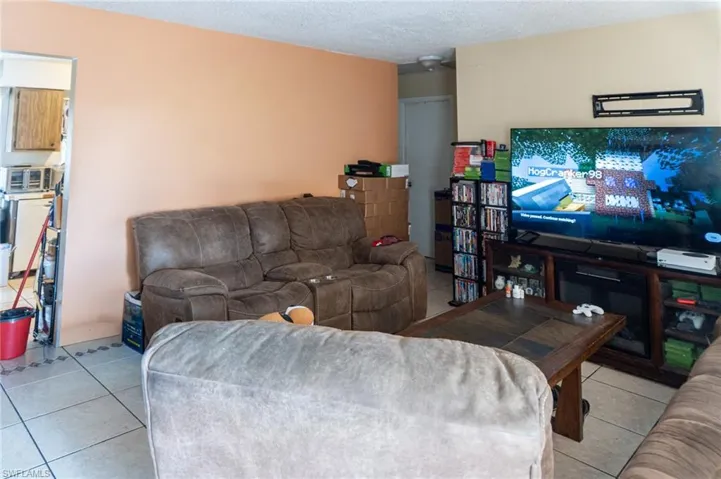 Living room featuring tile patterned flooring and a textured ceiling