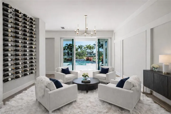 Living area with suspended lighting and wood finished floors