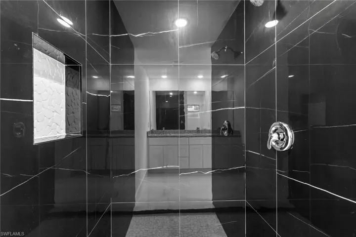 Full bath with vanity and tiled shower