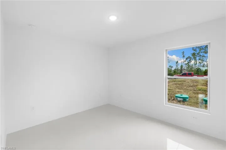 Spare room featuring recessed lighting and baseboards