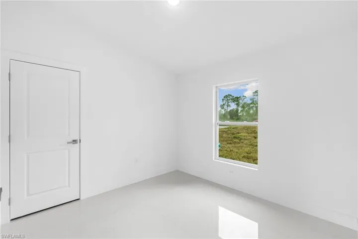 Empty room featuring baseboards