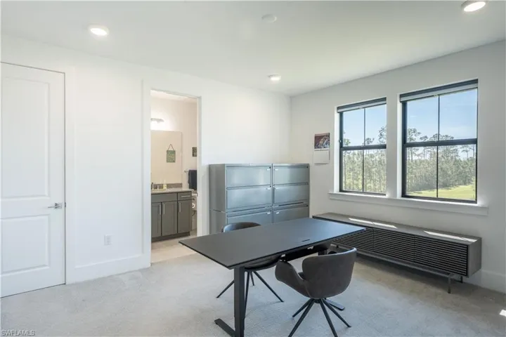 Office space with light colored carpet, baseboards, and recessed lighting