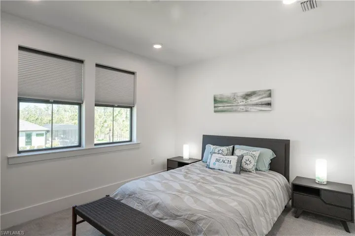Bedroom featuring carpet floors, baseboards, visible vents, and recessed lighting