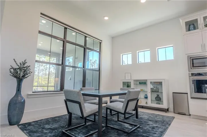 Dining area featuring recessed lighting and a towering ceiling