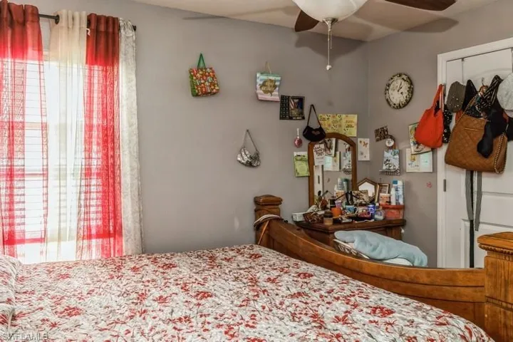 Bedroom featuring ceiling fan and multiple windows