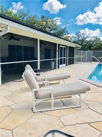 Modest Clubhouse and solar-heated community pool. There is a screened room, and the interior has a pool table and restrooms.