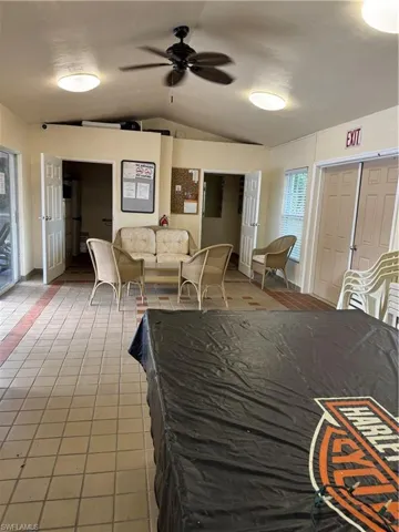 Modest Clubhouse with pool table, bathrooms, sink, microwave, TV, and refrigerator.