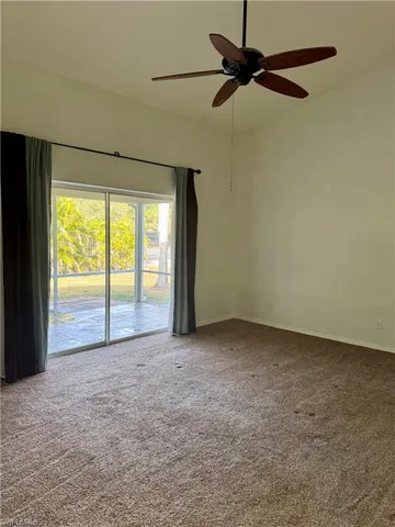 Spacious Primary bedroom with pocket sliding doors to an extra-large tiled lanai. Spacious high angled ceiling