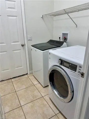 Interior Laundry Room with washer and dryer included.