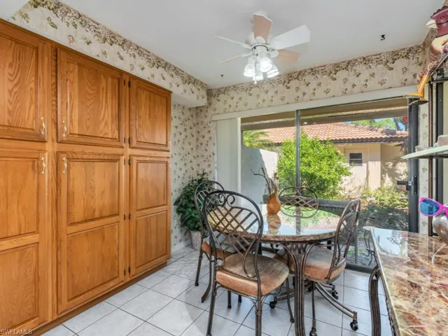 Dining area featuring light tile patterned floors and ceiling fan