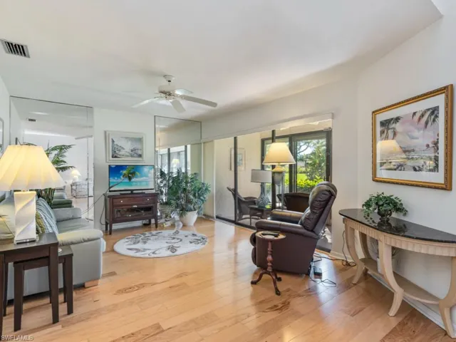 Living area with light wood-style flooring and a ceiling fan