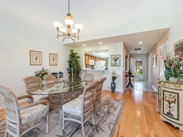 Dining space featuring light wood-style floors, recessed lighting, and a chandelier