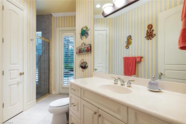 Guest/pool bathroom with vanity, toilet, and walk in shower