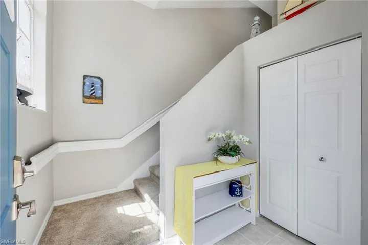 Entrance to this beautiful second floor unit with lots of natural light, a large entryway closet and plush carpeting on the stairway.