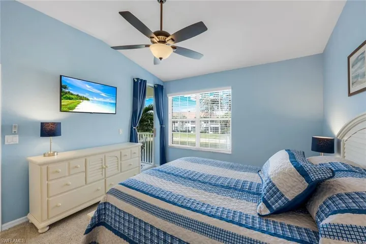 Spacious and bright primary bedroom with private access to the lanai, ensuite bathroom, a walk-in closet and additional closet.