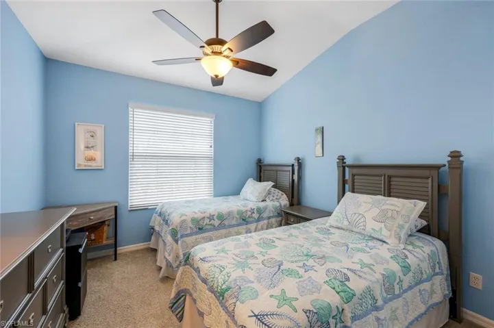 Second bedroom with new ceiling fan, plush carpeting, closet, and natural light.