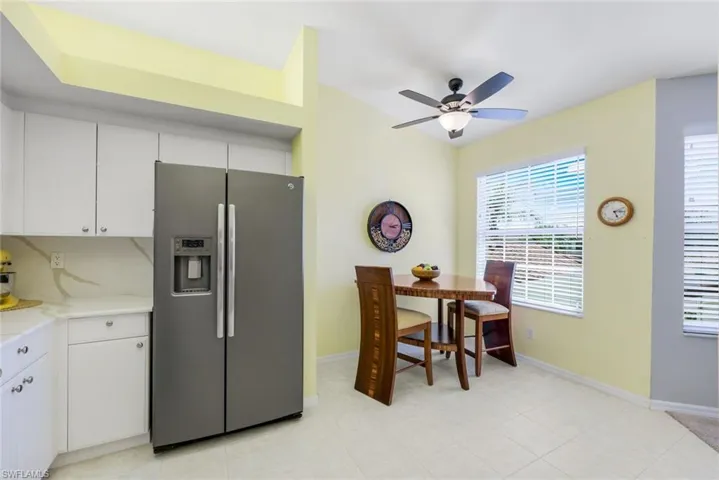 Lovely dinette area in the kitchen with plenty of natural light, new ceiling fan, tile flooring, and stainless steel appliances.